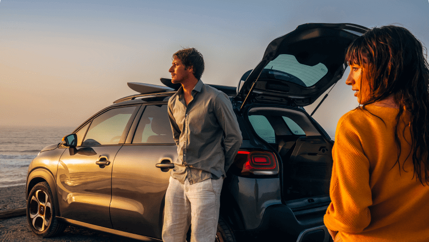 A couple is resting near a Citroën C3 Aircross after surf