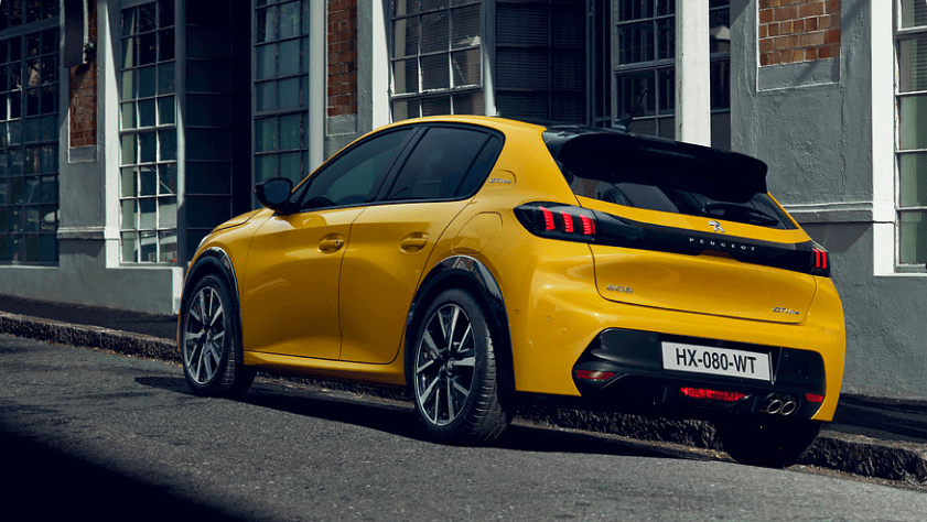 A yellow Peugeot 208 parked in the street