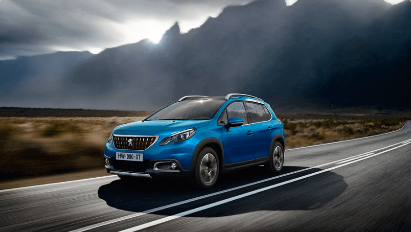A blue Peugeot 208 break on the road